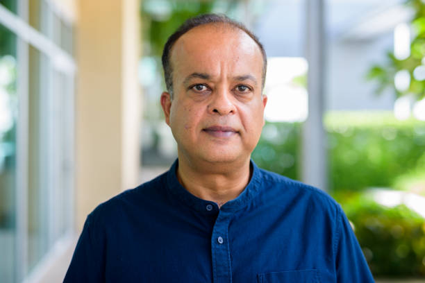 an old man wear blue shirt image